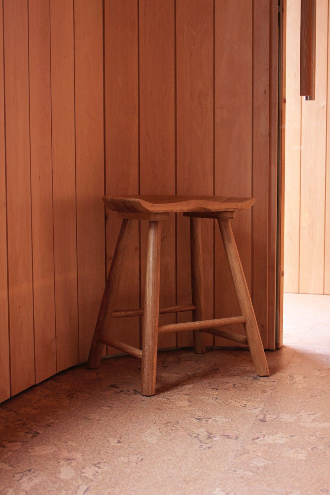 Cedar sauna interior with a hand-carved oak stool